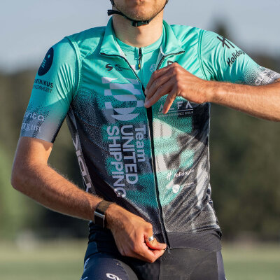 A model zipping up the team vest
